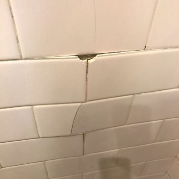 Severely cracked shower tiles causing shower to leak into the cavity behind 