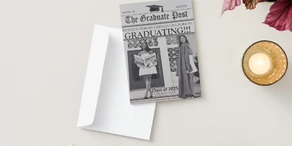 A graduation announcement card with an envelope on a white surface.