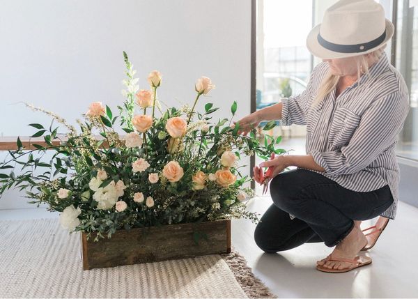 woman arranging flowers in photography studio