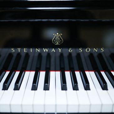 Close shot of Steinway & Sons piano keys w logo