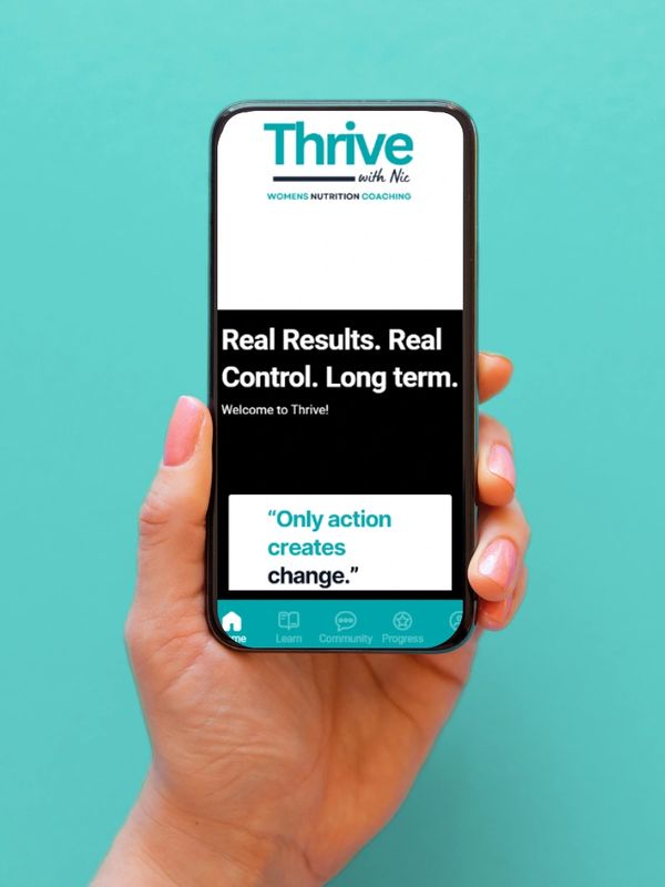 Woman's hand holding a mobile phone with the Thrive with Nic App open