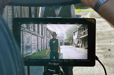 Camera monitor showing a person in cowboy attire.