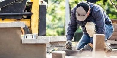 Labourer Laying Block Paving.