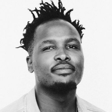 Black and white portrait of a man with a confident expression and styled hair.