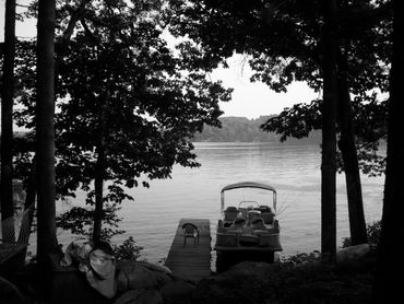 A view of a dock and boat, Mirror Lake, New Hampshire.