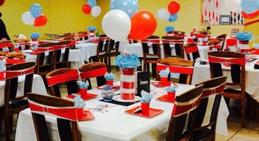 Party tables decorated with red, white, and blue balloons and table settings.