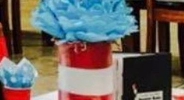 Party tables decorated with red, white, and blue balloons and table settings.