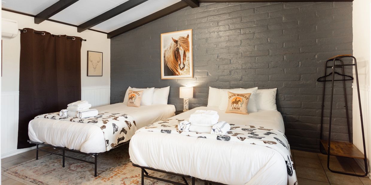Cozy bedroom with two beds and horse-themed decor.