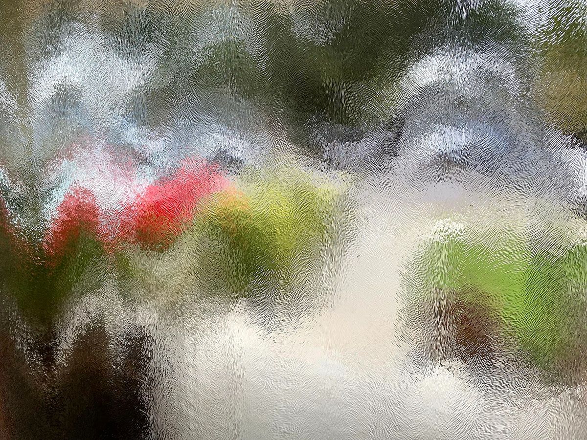 Abstract Image taken through textured glass, reds, greens, whites, it's whatever your mind sees...