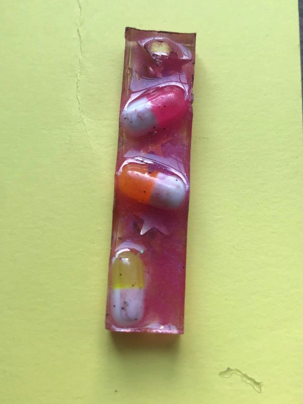 a piece leftover by a friend from the workshop! long pink rectangle with sunset colored pills inset