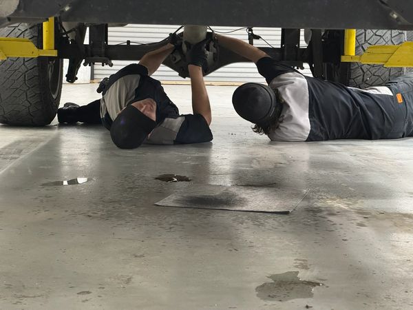 Chase and employee installing a driveshaft.