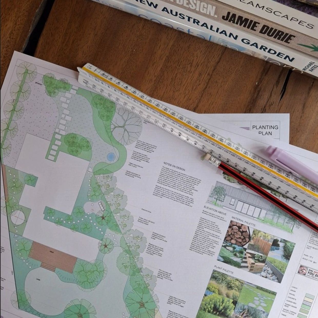 Landscape design plan with drawing tools and books.