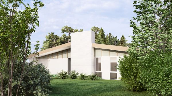 Modern white house with slanted roof surrounded by greenery.