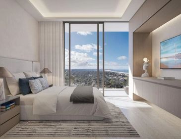 Modern bedroom with large window and city view.