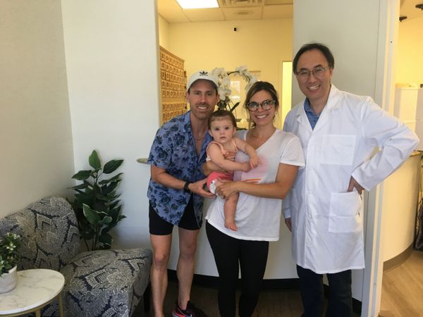 Dr. Yinan Wang with his miracle baby family he assisted with fertility treatments. 
