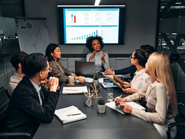 Young confident successful business people discuss and analyze work, statistics
