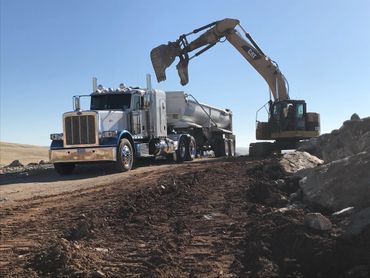 Hauling boulders for Parsons Rock Walls.