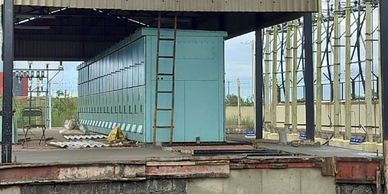 Large industrial blue container inside a warehouse.