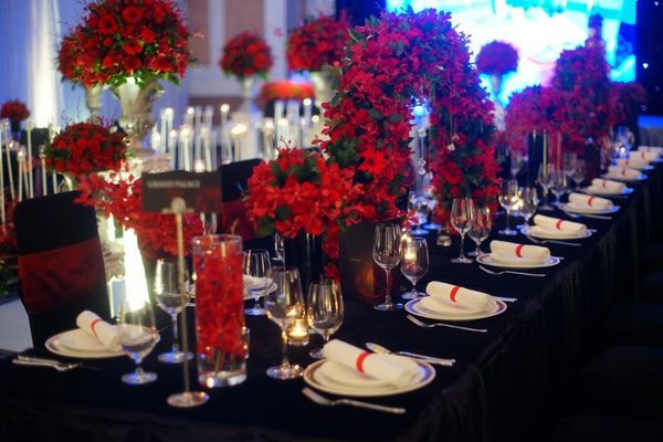 Red faux floral with wedding table set-up for reception