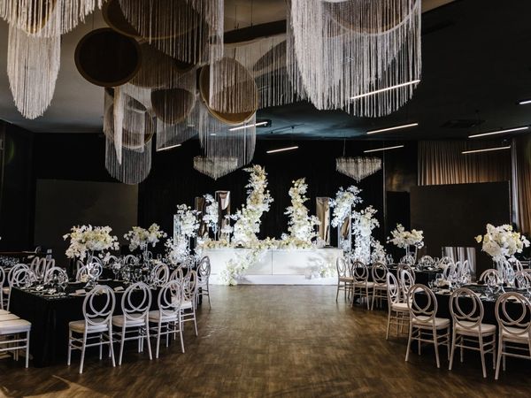 wedding reception, floral arch, chairs on stage, wedding planner designer, black and white wedding