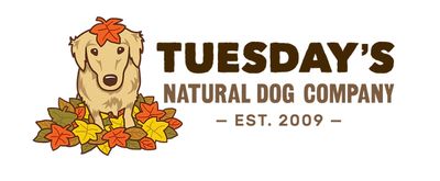 Logo featuring a dog surrounded by autumn leaves for Tuesday's Natural Dog Company.
