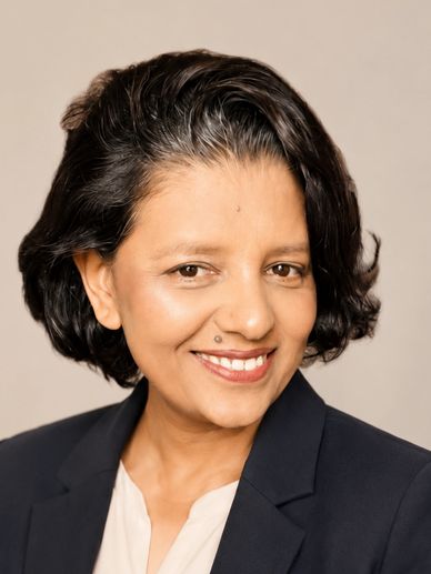 Professional portrait of a smiling woman with short hair.