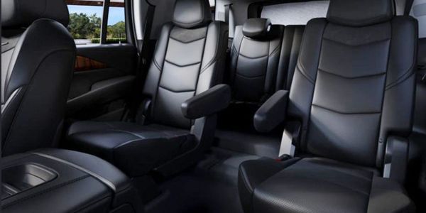 Luxurious black leather interior of a spacious vehicle with captain seats.