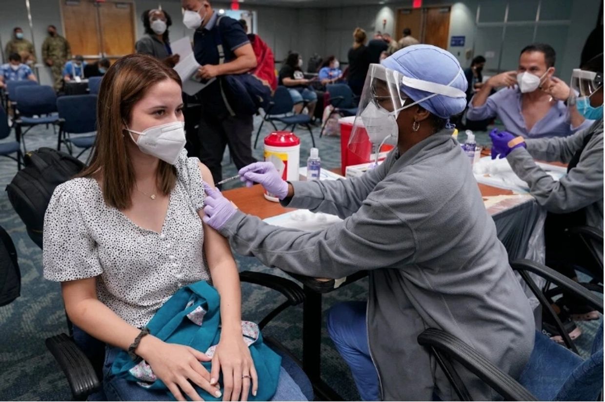 Young woman receiving a dose of a COVID-19 vaccine at a walk-in clinic in the United States in 2021.