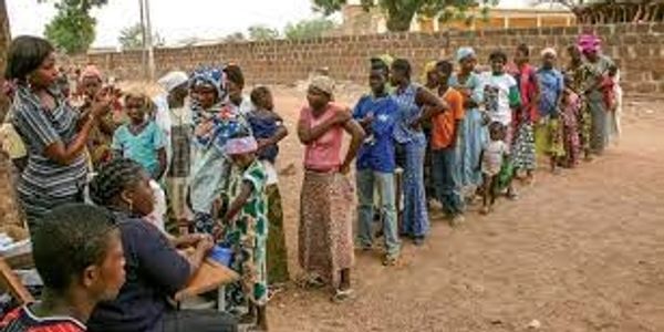 Queue of people lining up for essential immunizations in a third world country, supported by the WHO