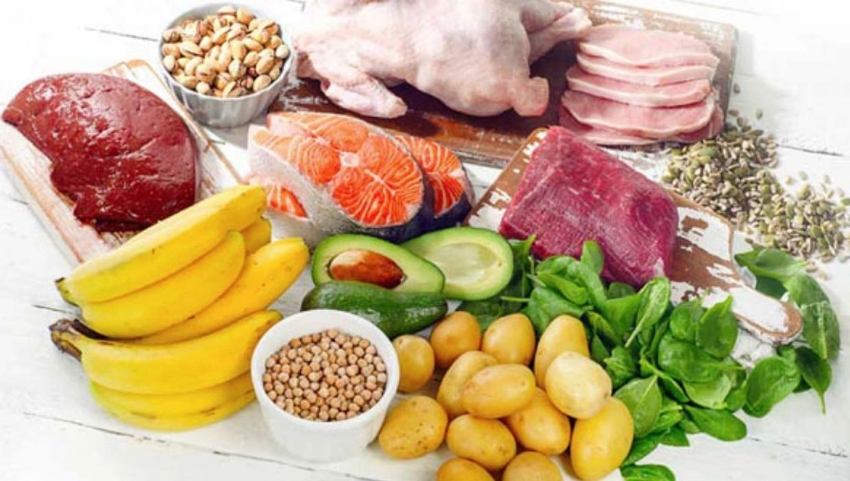 Varied assortment of foods, all of which contain significant amounts of Vitamin B, on a table-top.