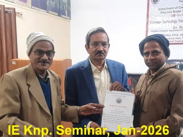 Three men holding a certificate at IE Knp. Seminar, January 2026.