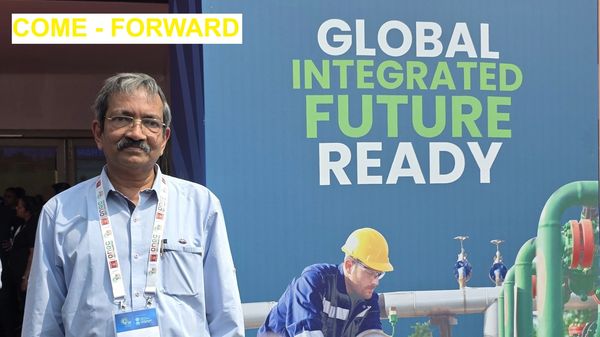 Man standing near a banner promoting global integrated future readiness.