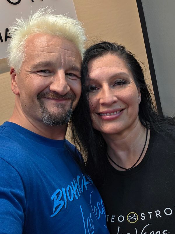 Smiling couple taking a close-up selfie indoors.