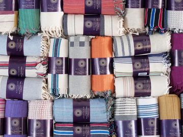 A colorful assortment of folded scarves with various patterns and textures.