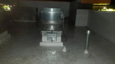 Metal ventilation equipment installed on a rooftop at night.