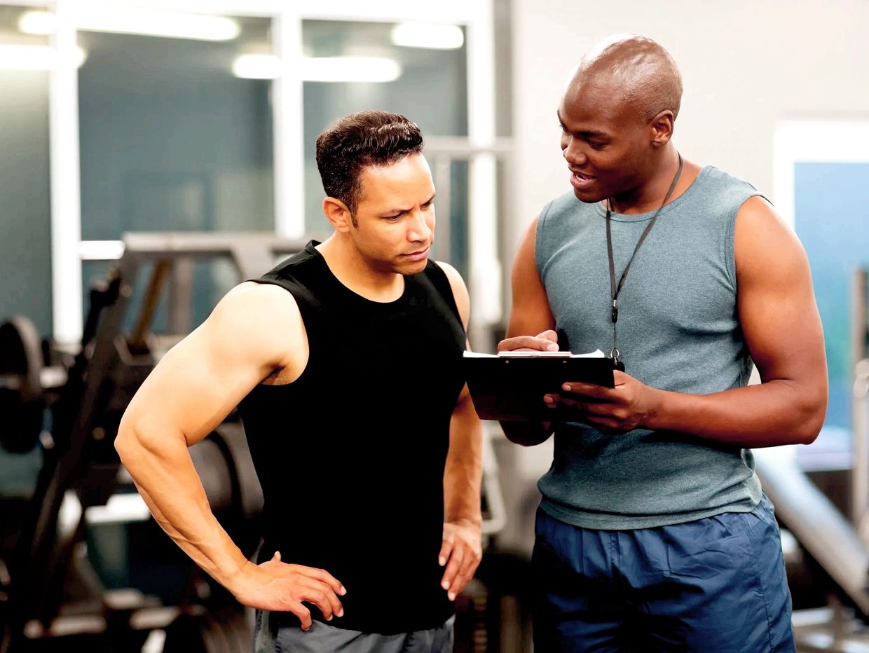 In training: coach and executive progressing on a workout plan