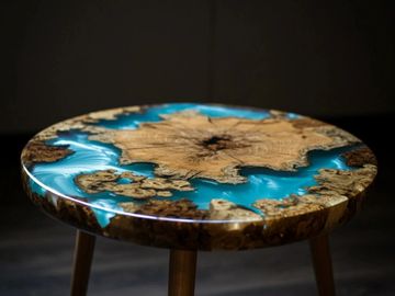 Round table with wood and blue resin river design.