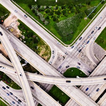 Aerial view of a complex highway interchange with multiple overpasses and vehicles.