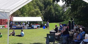 People enjoying an outdoor event on a sunny day.