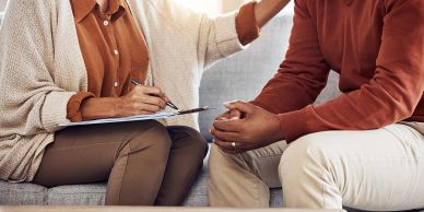Counselor providing support to a client during a therapy session.