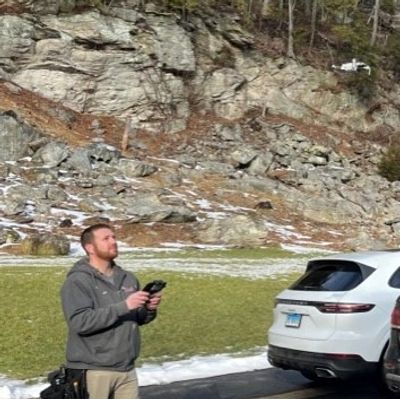 FAA Certified Drone Pilot and Home Inspector Joe flying a drone to perform a roof inspection