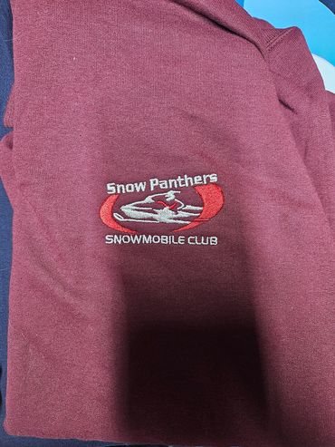 Maroon shirt with Snow Panthers Snowmobile Club logo.
