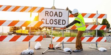 Lane Closure Technician (LCT) posting a Road Closed Sign