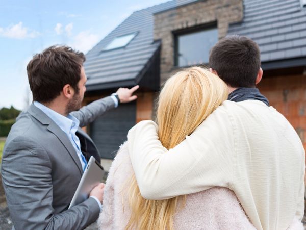 View of a Real estate agent shows details to customers