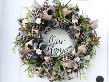 Farmhouse style wreath with sign that wreaths "Welcome to Our Home".