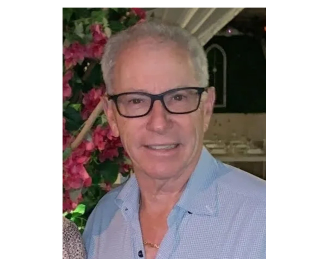 a photo of Dr.Markowitz with a blue shirt and black glasses on.