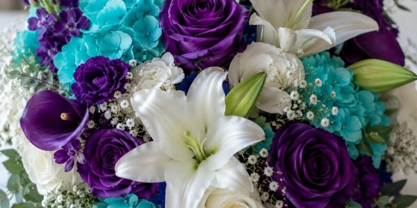 A vibrant bouquet of blue, purple, and white flowers.