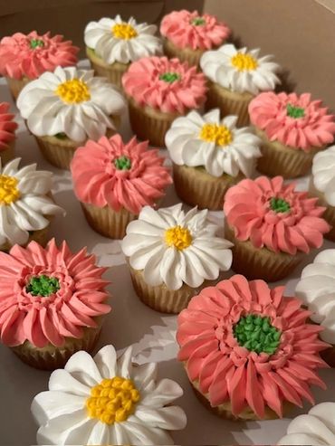 Gerber pink daisies and whte daisies in a bakery box.