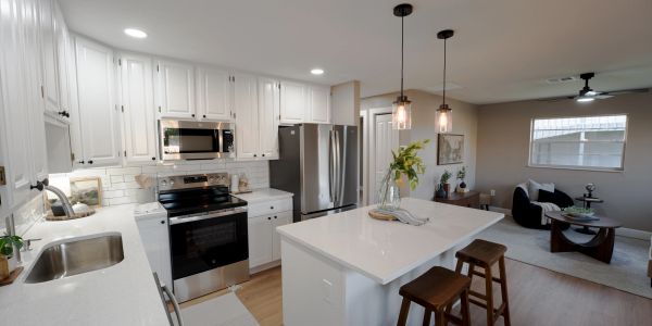 Modern kitchen with white cabinets and island.