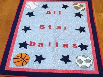 Crib sized quilt with a sports theme. Features baby's name. 